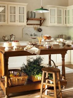 a kitchen filled with lots of wooden furniture