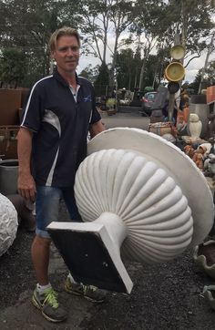 a man standing next to a large white object