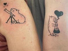 two people with tattoos on their arms and one is holding a balloon in the shape of a dog