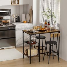 the kitchen is clean and ready to be used for cooking or baking, while also being used as a small dining table