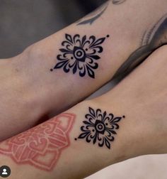 two people with tattoos on their legs