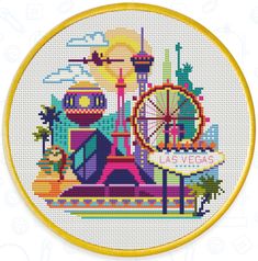 a cross stitch pattern with the las vegas sign and ferris wheel in front of it