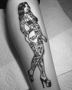 a woman's leg with tattoos on it