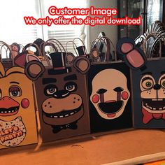 several bags with cartoon faces on them sitting on a table