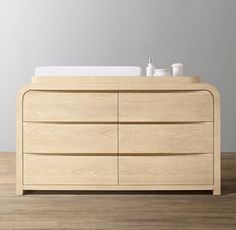 a wooden dresser sitting on top of a hard wood floor