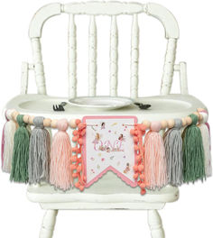 a white chair with tassels on it