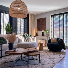 a living room filled with furniture and lots of windows