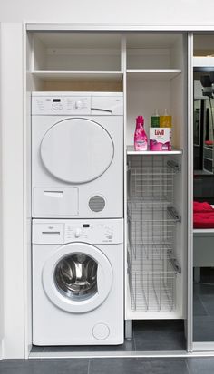 a washer and dryer are in the closet next to each other on the floor