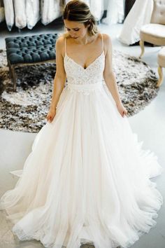 a woman in a wedding dress looking down at the floor