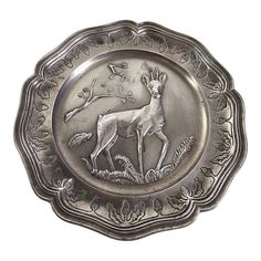 a silver plate with a deer on it