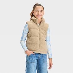 Refresh your child's outerwear with this Solid Puffer Vest from art class™. This solid-color vest features a stand collar and a full-length zipper down the front, making it easy to layer over their tops and dresses. Crafted from midweight recycled polyester, the vest boasts full lining and showcases classic channel-stitched quilting for added warmth. art class™: One-of-a-kind looks for the one and only you. Neutral Puffer Vest, Zara Cream Puffer Vest, Tan Puffer Vest, Puffer Vest Tan, Kids Puffer Vest, Girls Fleece, Kids Outerwear, Puffer Vest, Crew Sweatshirts