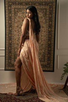 This baby peach pre-draped saree is a vision of elegance, crafted from Linen Satin fabric that glimmers with every movement. Paired with a Net blouse, the ensemble radiates sophistication and charm. The intricately hand-embroidered blouse adds a touch of glamour, making it perfect for a cocktail or reception, whether for the bride or her bridesmaids. With its timeless allure and delicate detailing, this saree is sure to captivate attention and leave a lasting impression on any special occasion.F Festive Peach Pre-draped Saree With Unstitched Blouse, Peach Georgette Saree With Unstitched Blouse, Elegant Draped Sharara With Pallu, Elegant Peach Georgette Lehenga, Peach Georgette Saree For Party, Bollywood Style Peach Pre-draped Saree, Bollywood Style Peach Saree For Reception, Elegant Semi-stitched Peach Choli, Elegant Peach Sharara For Reception