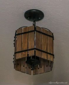 a wooden light fixture hanging from the ceiling