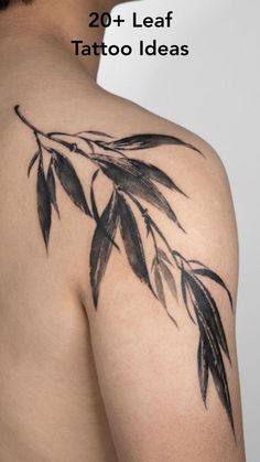 the back of a man's shoulder with tattoos on it and leaves in black ink