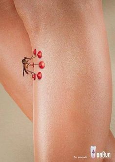 a woman's legs with small red berries on it and the bottom part of her leg