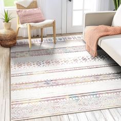 a living room area with a white couch, chair and rug