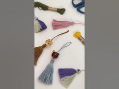 various tassels are arranged on a white surface