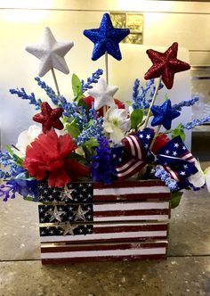 an american flag flower arrangement in a wooden box