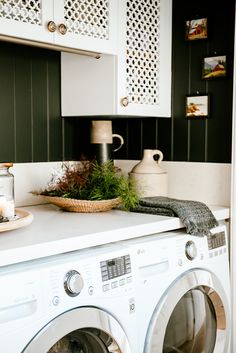 a white washer sitting inside of a kitchen next to a dryer