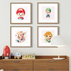 four framed mario kart pictures hanging on the wall above a dresser and toy chest