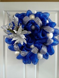 a blue wreath with silver and white decorations