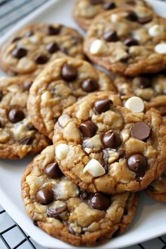 chocolate chip cookies on a white plate with marshmallows and chocolate chips in the middle