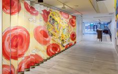 an art gallery with colorful paintings on the walls