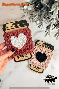 two crocheted coffee mug cozyies sitting next to each other