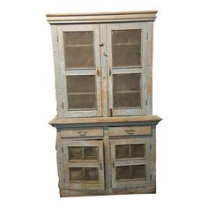 an old wooden cabinet with glass doors and drawers on the front, against a white background