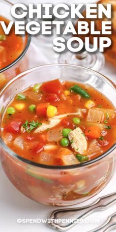 two bowls filled with chicken vegetable soup on top of a table