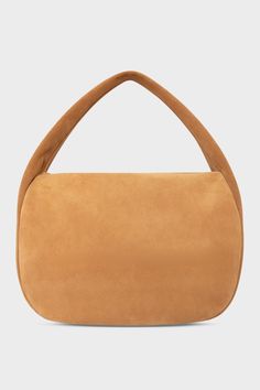 A large suede shoulder bag in the color tan. The handbag has a hobo inspired design. Modern Suede Hobo Bag With Double Handle, Modern Double Handle Suede Hobo Bag, Modern Suede Tote Hobo Bag, Modern Rectangular Suede Hobo Bag, Modern Suede Shoulder Bag With Handle Drop, Modern Suede Bag With Zipper Closure, Luxury Designer Bags, Designer Shoulder Bag, Holiday Bag