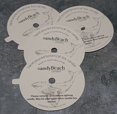 four discs with the words sandy beach printed on them