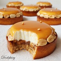 several desserts with peanut butter and bananas on top are sitting on a white surface