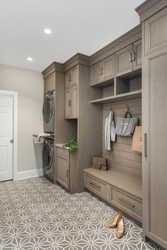 a laundry room with an open door and lots of cabinets