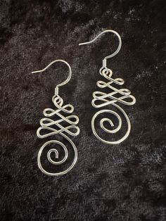 "These silver infinity swirl earrings are lightweight and easy to wear any day. They will add some artsy flair!  * Nickel Free Earwires  * full length is approximately 2\" ----------------------------------- -- Browse all of my Earrings here:   https://www.etsy.com/shop/fatcatbeads?ref=profile_header§ion_id=42122010 -- Browse my Ear Cuffs for a fun, non- pierced option here:   https://www.etsy.com/shop/fatcatbeads?ref=profile_header§ion_id=41872727 -- Organize your earrings on one of my Handmade Silver Swirl Wire Wrapped Earrings, Silver Spiral Wire Wrapped Earrings, Nickel Free Silver Wire Wrap Earrings, Jewelry Silver Earrings, Jewelry Designing, Wire Jewelry Designs, Earrings Wire, Swirl Earrings, Nickel Free Earrings