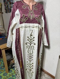 This is a gorgeous vintage kaftan with embroidered embellishments.  The label does not indicate size.  I believe it is an XL to 1x in size.  I added a photo of the measurement across the waist area and the length of the sleeve.  There are gold rope ties in the front and the back.  I believe the fabric is a heavy jacquard but I am not sure.  I searched translation on the label and believe it was made in Syria.  It is a beautiful well made kaftan Vintage Kaftan, Embroidered Kaftan, Syria, Dress Clothes For Women, The Label, Favorite Outfit, Art Collection, Dress Outfits, Bathing Beauties