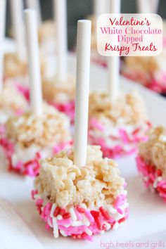 valentine's white chocolate dipped krispy treats with pink sprinkles on them