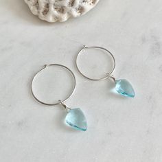 Dainty little aquamarine faceted crystal gemstone hoop earrings in 20mm sterling silver or 14k gold filled hoops. Option for gold plated and silver plated are less expensive. Please see drop down. Perfect for March birthdays! 💙Aquamarine, a stone of serenity, calms and soothes with it's lovely blue/green color and evokes the calm of the water with it's given name, which is interpreted at 'water of the sea' derived from Latin. A stone that celebrates the sea goddess of ancient times, it was carr Blue Hypoallergenic Hoop Jewelry, Hypoallergenic Blue Hoop Jewelry, Sterling Silver Huggie Drop Earrings With Gemstone, Blue Hypoallergenic Small Hoop Jewelry, Hypoallergenic Blue Small Hoop Jewelry, Minimalist Sterling Silver Gemstone Huggie Earrings, Small Hoop Birthstone Jewelry For Everyday, Nickel-free Blue Small Hoop Jewelry, Everyday Small Hoop Birthstone Jewelry