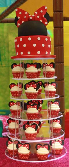 cupcakes are arranged in the shape of minnie mouse ears on top of each other