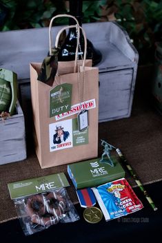 a brown paper bag sitting on top of a wooden table next to other bags and items