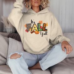 Wrap yourself in the essence of the season with our Hoodie Sweatshirt featuring a captivating Fall Graphic design. Embrace the cozy vibes and autumn spirit exuded by this stylish sweatshirt. With a nod to the season, the "It's Fall Y'all" message on the hoodie adds a touch of playfulness and charm. Made for those crisp days and cool evenings, this sweatshirt will keep you snug and fashionable all at once. Whether you're out for a casual stroll or lounging indoors, this Fall-inspired hoodie is the perfect blend of comfort and flair. Elevate your fall wardrobe with this must-have piece that captures the essence of the season beautifully. Fall Hooded Sweater With Letter Print, Fall Letter Print Hoodie Sweatshirt, Fall Cotton Hooded Hoodie, Cotton Hooded Hoodie For Fall, Fall Hooded Sweater With Graphic Print, Fall Hoodie Sweatshirt With Drawstring Hood, Fall Cotton Hooded Sweatshirt, Fall Graphic Print Hoodie Sweater, Fall Graphic Print Hoodie With Crew Neck