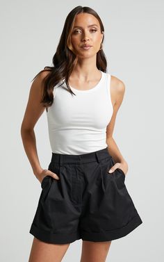 Add a touch of sophistication to your summer wardrobe with our Khaimy Shorts. These high-waisted, tailored shorts in classic black are the perfect addition to any casual ensemble. Made from 100% cotton, these shorts offer ultimate comfort and breathability for those warm days ahead. The cuffed hem adds a stylish twist to this timeless design, making them an essential piece for fashion-forward individuals like yourself. Whether you're heading out for brunch or lounging by the pool, our Khaimy Sho Tailored Shorts, Shorts Casual, Cuffed Shorts, The Pool, High Waisted Shorts, Summer Wardrobe, Short Outfits, Over 50, Classic Black