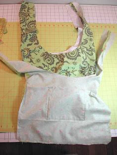 an apron is laying on top of a cutting mat