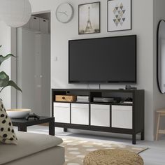 a flat screen tv sitting on top of a entertainment center