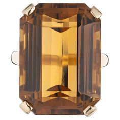 Vintage 1960's burnt orange ( Madera ) color emerald cut citrine ring cocktail ring. Stunning 36.60 Carat Madera Emerald Cut Citrine set in a 14k yellow gold setting. The citrine color is vibrant and rich with yellow and orange hues. The Madera citrine is known for its exceptional clarity and brilliance, the emerald cut not only enhances the stone's natural beauty, but also creates a unique and modern look. 1 rectangular emerald cut yellowish orange citrine, approx. 36.60cts Size 6.5 and sizable Orange Citrine, Antique Wedding Bands, Yellow Gold Cocktail Ring, Diamond Sapphire Engagement Ring, Antique Engagement Rings Vintage, Orange Hues, Antique Bracelets, Vintage Sapphire, Diamond Engagement Rings Vintage