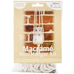 the macrame mini hanger kit is packaged in a package with white string