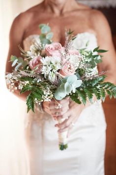 a woman holding a bouquet of flowers in her hands