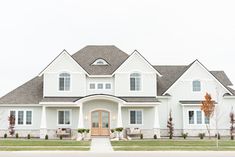 a large white house sitting on the side of a road