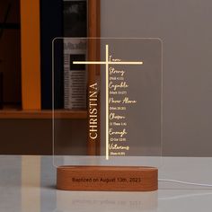 a glass plaque with the names of different churches on it sitting on a table in front of a bookcase