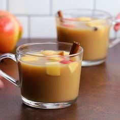 two glasses filled with hot chocolate and apples